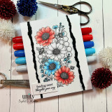 Card with the daisy panel in coral and blue split by a torn black strip, with the sending sweet thoughts your way sentiment, staged with markers.