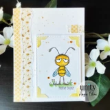 Clean card with a grumpy bee over a yellow floral border and 'mother buzzer.'