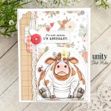 Card with the brown-and-white grumpy cow on a soft floral background, stamped 'I'm not extra. I'M ABUNDANT.'
