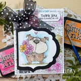 A scruffy, goofy-eyed pup clutches a bouquet of pink, yellow and orange daisies with a tiny heart overhead, layered on a text-print panel with a black polka-dot bow; the sentiment reads "Thank you, with flowers on top."