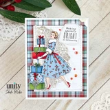 Card with the woman in a blue cherry-print dress beside stacked presents on an embossed white panel over red and navy plaid, sentiment "Making spirits BRIGHT is exhausting."