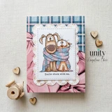 A soft pink card with the shaggy dog and the wide eyed cat bundled into one long knit scarf, colored in tan and grey, above a small banner reading 'You're stuck with me.'