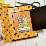 An orange heart print folio card with the dog and cat wrapped in a yellow scarf, finished with the sentiment 'You're stuck with me.'