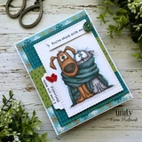 A teal patchwork card with the dog and cat in a grey blue scarf, two small red hearts and a banner reading 'You're stuck with me.'