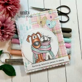 Card with the dog and cat wrapped in one knit scarf, coloured in soft pink and grey, on a circle over pastel plaid paper with markers and a flower beside it, sentiment "You're my favorite person to annoy."