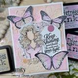 Sample card with the girl colored cream and blush among large lavender butterflies and a 'Keep Shining' tag.