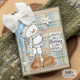 Snowbert card with the snowman in a pale blue stocking cap and cream striped scarf, brown boots, a white bow at the top and 'wishing you a flurry of happy moments.' over blue and tan plaid