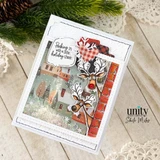 Shaker card with a snowy village scene and a red brick wall: the two goggle-eyed reindeer with red noses peeking around the bricks, plaid heart, and 'Peeking in with a little holiday cheer.' in a speech bubble.