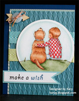 Card with the boy in red checks and his dog inside a white circle on a teal embossed panel, 'make a wish' on a blue banner with a small airplane charm.