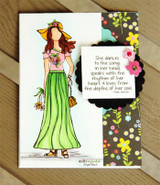 Card with a hand colored girl in a yellow hat and long green skirt holding a basket of flowers, beside floral paper and the quoted verse 'She dances to the songs in her head, speaks with the rhythm of her heart, & loves from the depths of her soul'.