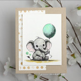 Card with a baby elephant holding a balloon over a lightly dotted background.