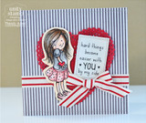 Card with the girl in a blue top and pink skirt beside a red doily heart on gray pinstripes, tied with a red and white striped ribbon.