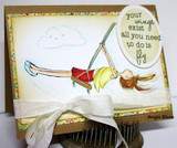 Vintage patterned card with a soft blue sky panel, the girl colored in a red top and yellow skirt on her swing, and an oval sentiment tag tied with white ribbon.