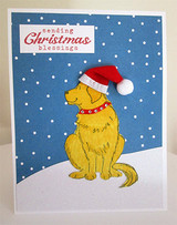 Blue snowy card with the golden dog in a Santa hat and a red collar under a Christmas sentiment label