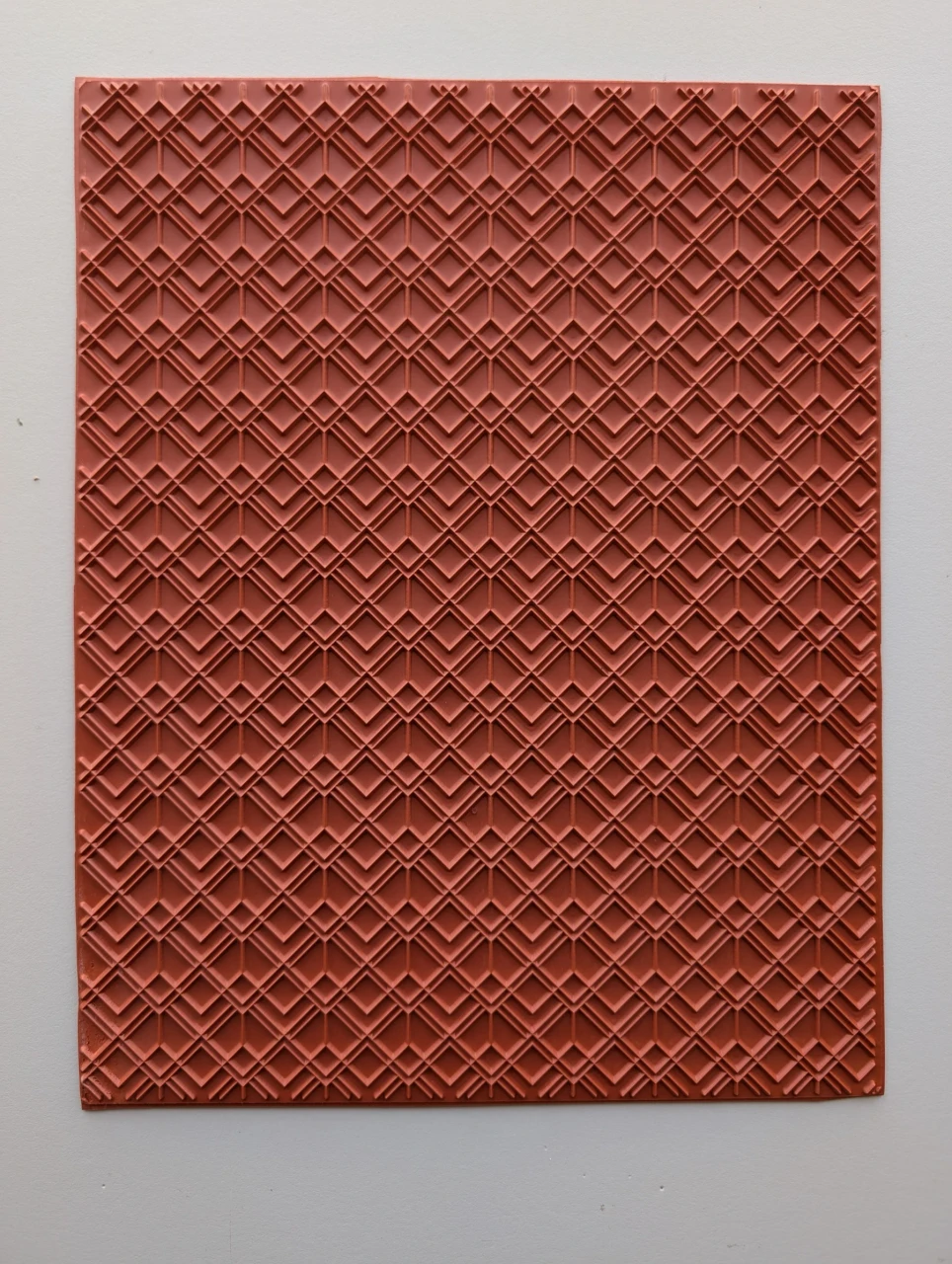 Full red rubber pottery texture mat with layered geometric diamonds in a repeating pattern.