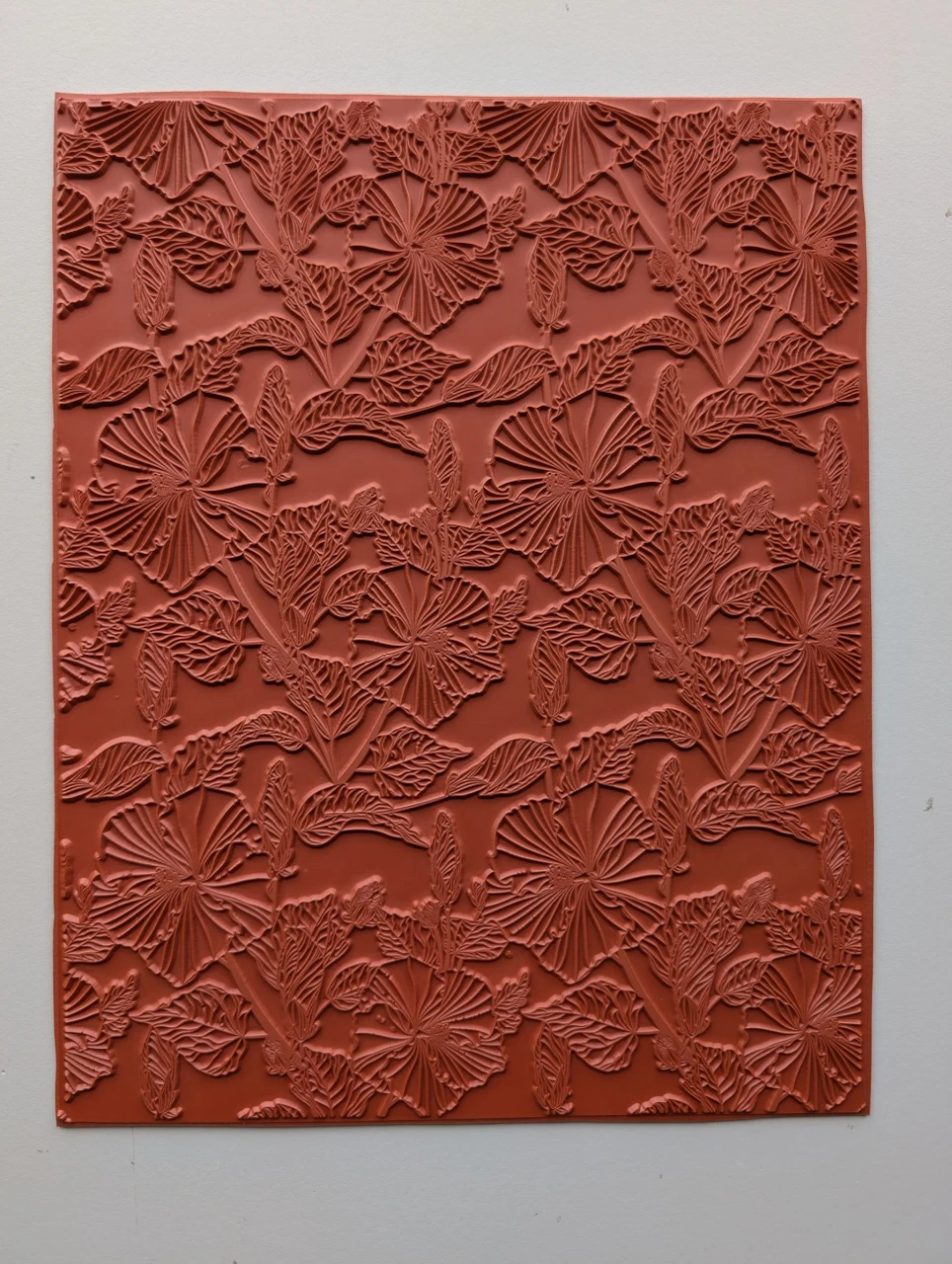 Full 10 × 12 red rubber Tropical Bloom texture mat with large tropical flowers and layered veined leaves.