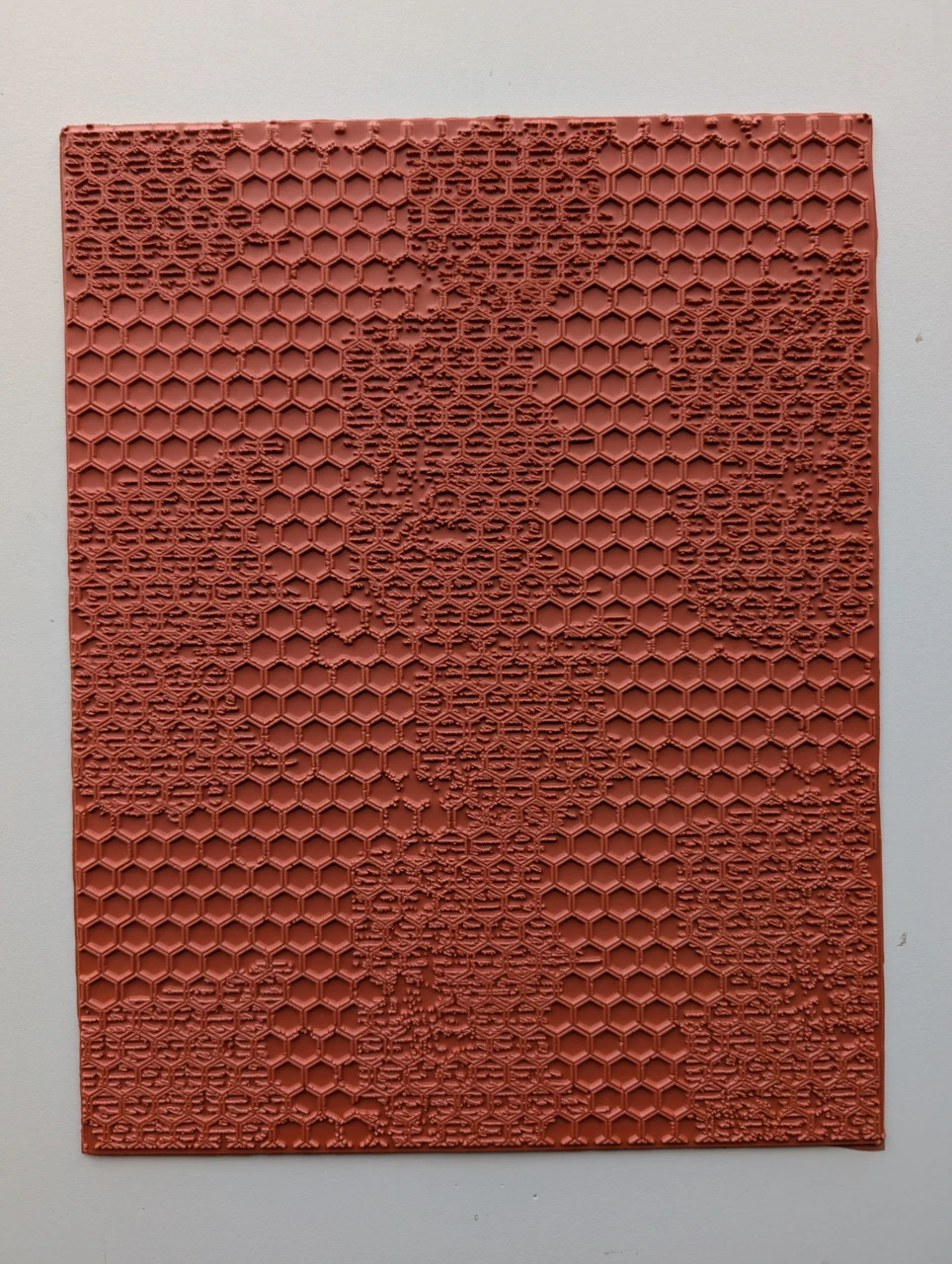 Full 10 × 12 red rubber Distressed Honeycomb texture mat with open hexagons and irregular weathered texture.