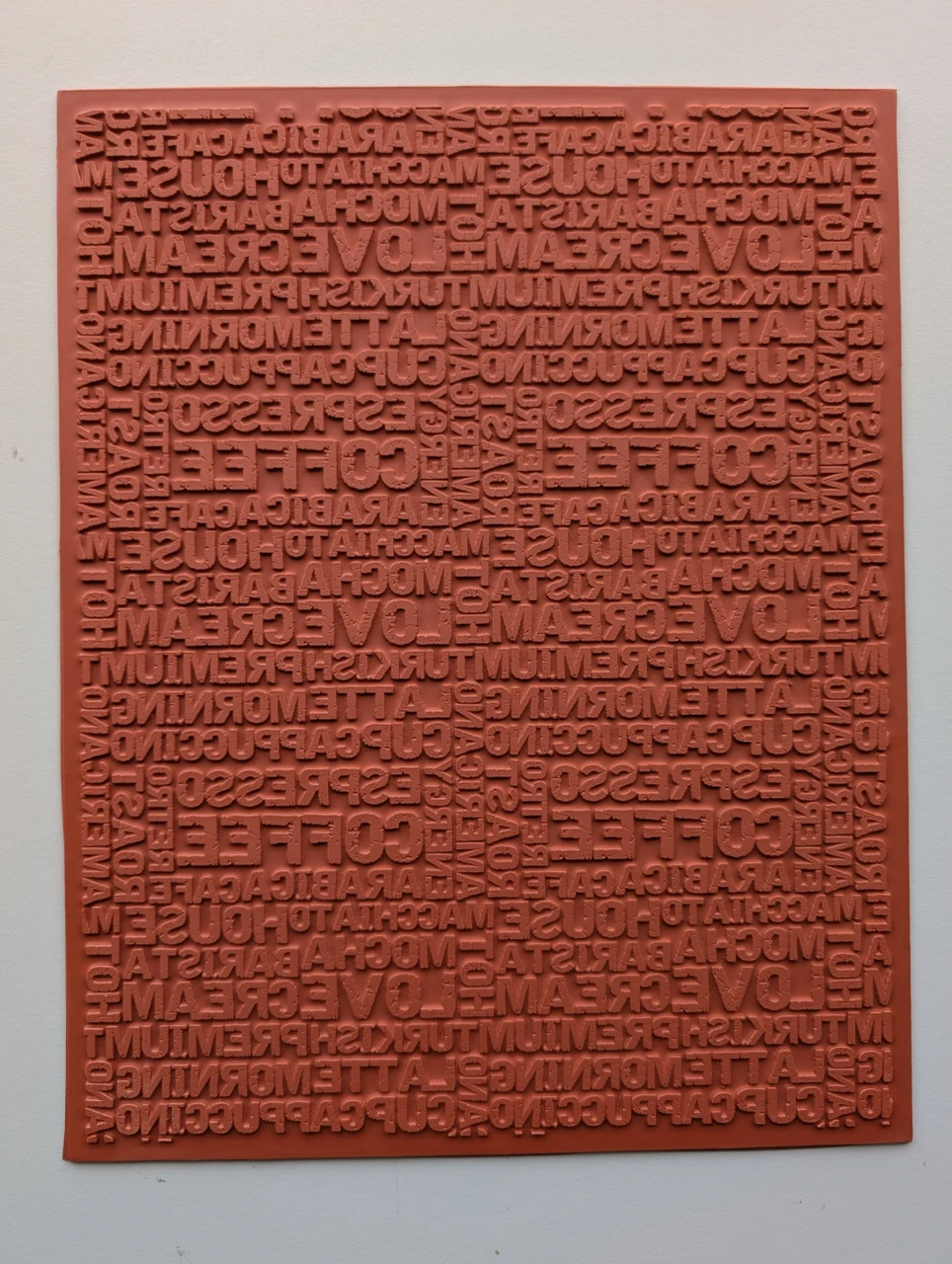 Full 10 × 12 red rubber Distressed Alphabet texture mat with layered uppercase letters and worn surface marks.