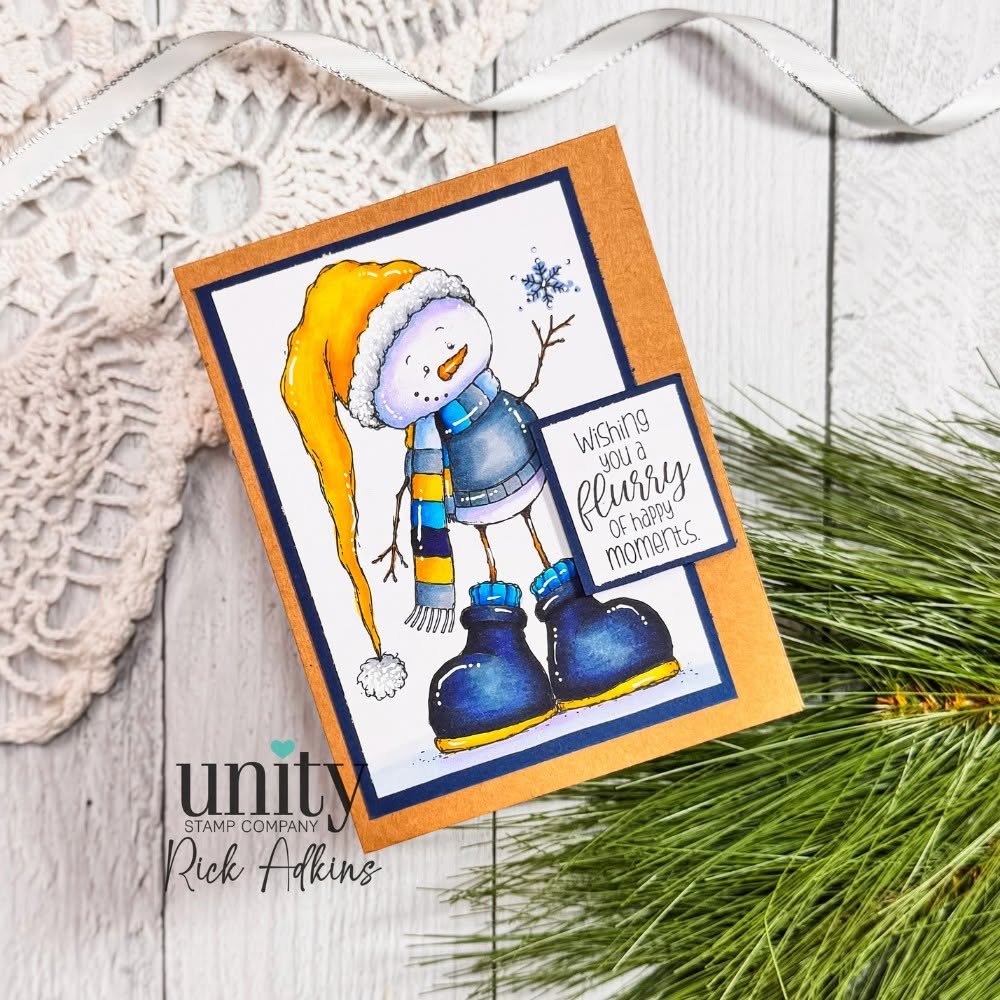 Handmade card made with Unity Stamp Co's Snowbert red rubber stamp set: the snowman in a yellow cap and blue boots with the "wishing you a flurry of happy moments." sentiment.