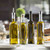 TableCraft Products 916 16 Oz. Square Green Tinted Glass Prima Bottle With Stainless Steel Pourer