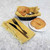 TableCraft Products 975B 9" W x 6 1/2" D x 2 1/2" H Oval Black Vinyl Hand Woven Basket With Gold Metal Trim