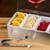 TableCraft Products 1604 12" W x 5 3/4" D x 3 1/2" H 1 Pint 4 Compartment Holder Stainless Steel With Acrylic Lid Condiment Holder