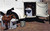 Dry Camp Water Tank and Saddle Rack; this water caddy maximizes space by storing 30 gallons of water while holding two saddles. Show in a typical setup being used in a bumper pull horse trailer's storage area.