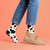 AI-generated styling image of Moo! Cow Socks For Women — worn, with shoes