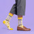AI-generated styling image of I'm Out Of Fucks So Here's A Rat's Ass Socks — worn, with shoes