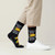 AI-generated styling image of Tacos Fall Apart Socks — worn, with shoes