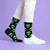 AI-generated styling image of Come In Peace Alien Socks For Men — worn, with shoes