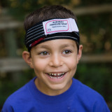 NEW! Slishman Pressure Wrap, black, on pediatric head