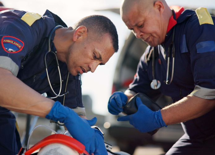 Two ems applying life saving care