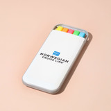 A highlighter set in a white case featuring yellow, orange, pink, and green highlighters, with a logo on the case.