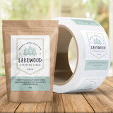 A roll of stickers featuring a logo and packaging design for Lakewood organic loose leaf tea in natural colours.