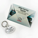 A key tag and a grey presentation folder featuring a logo and an image of a car.