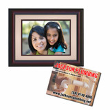 A magnetic photo frame in dark wood with a light border, holding a photo of two women smiling.