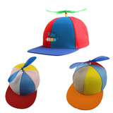 A multicoloured cap featuring a propeller on top. The colours include red, blue, yellow, and orange. It has a logo.