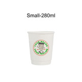 A white double wall paper cup with a circular logo, featuring a cartoon character and text in green and red.