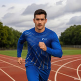 A man in a blue long-sleeved shirt runs on a track, with a logo on his shirt and a cloudy sky above.
