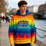 A brightly coloured unisex hoodie featuring rainbow stripes and a logo, worn by a model near a river.