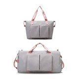 A grey foldable sports duffle bag with pink straps and front pockets, shown in two different sizes.