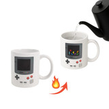 A heat-sensitive colour changing mug in white, resembling a retro gaming console, with a pouring kettle above.
