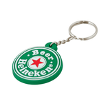 A green moulded PVC keyring featuring a circular design and a logo. It has a silver keychain attached.