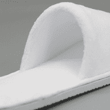 Open toe hotel slippers in white, featuring a soft, plush design and a textured sole.