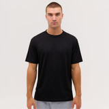 A black t-shirt displayed on a model, featuring a simple design and short sleeves. It has a logo on the front.