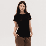 A black women's tee with a round neckline and short sleeves, modelled by a woman with long hair.