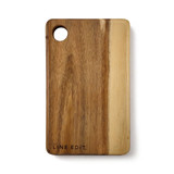 An acacia serving board in warm brown tones, featuring a circular cut-out and a logo on the side.