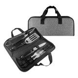 A BBQ set with metal tools including a spatula, fork, knife, and tongs, contained in a grey carrying case.