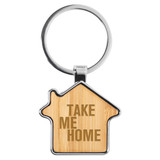 A bamboo key ring shaped like a house with a silver keychain attachment and a logo.